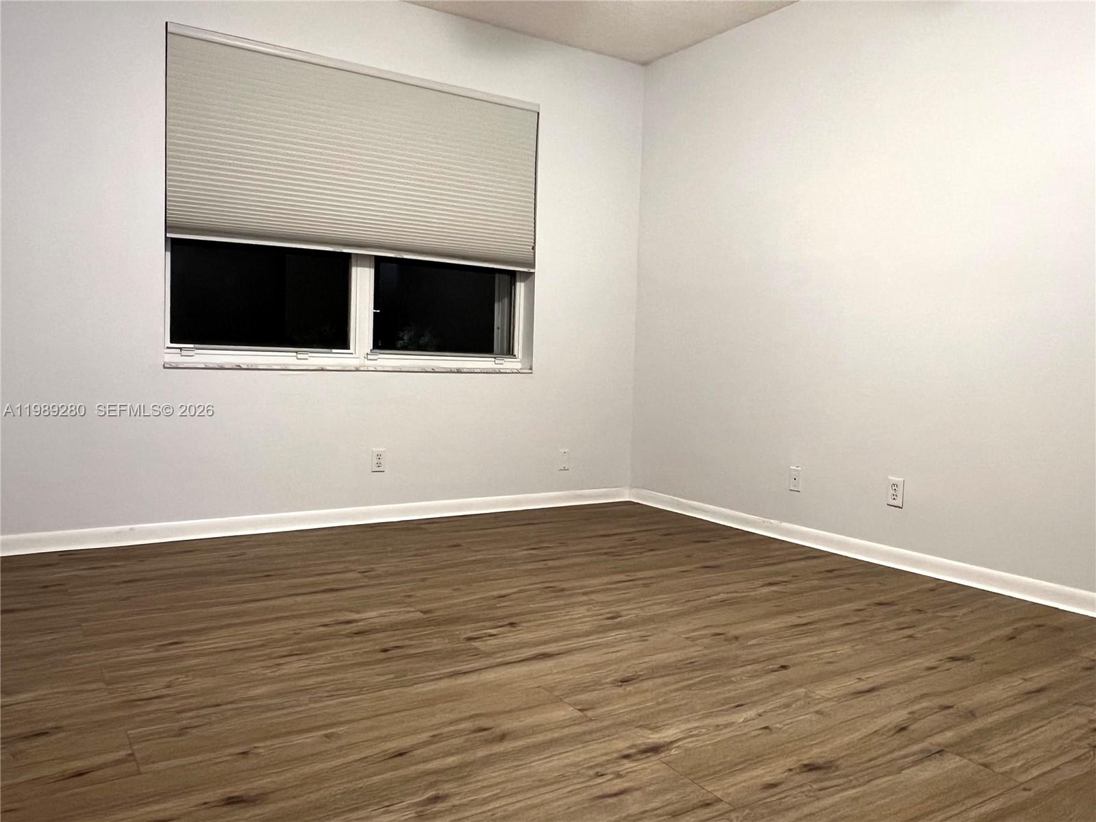 543 Racquet Club Road, Unit 33 Weston, FL 33326 - Photo 17 of 28 a view of an empty room with wooden floor