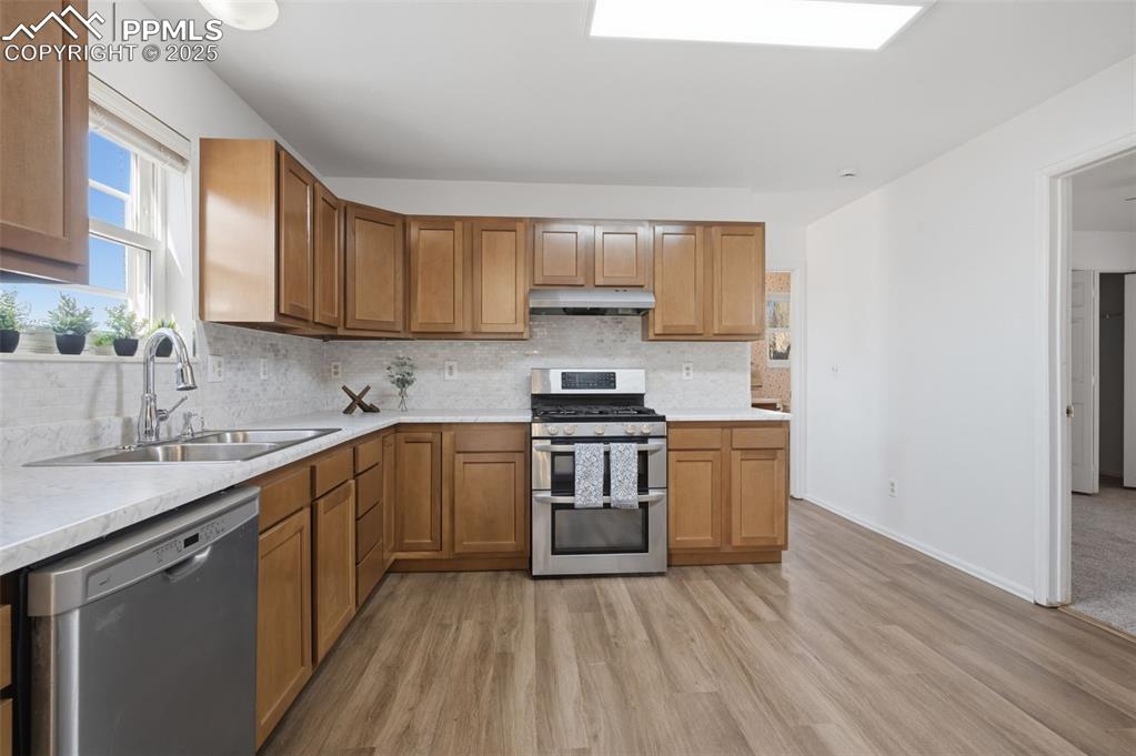 747 D Street Penrose, CO 81240 - Photo 11 of 36 a kitchen with a sink stove top oven and cabinets