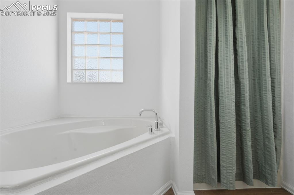 747 D Street Penrose, CO 81240 - Photo 19 of 36 a white bath tub sitting next to a window