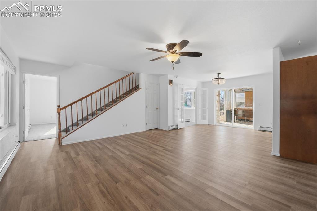 747 D Street Penrose, CO 81240 - Photo 6 of 36 a view of an empty room with wooden floor and a ceiling fan