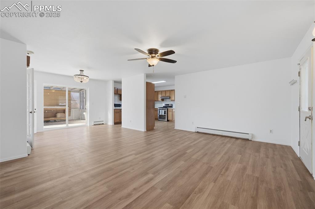 747 D Street Penrose, CO 81240 - Photo 7 of 36 wooden floor in an empty room with a window