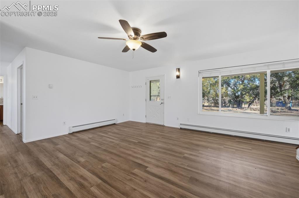 747 D Street Penrose, CO 81240 - Photo 8 of 36 a view of empty room with wooden floor and fan