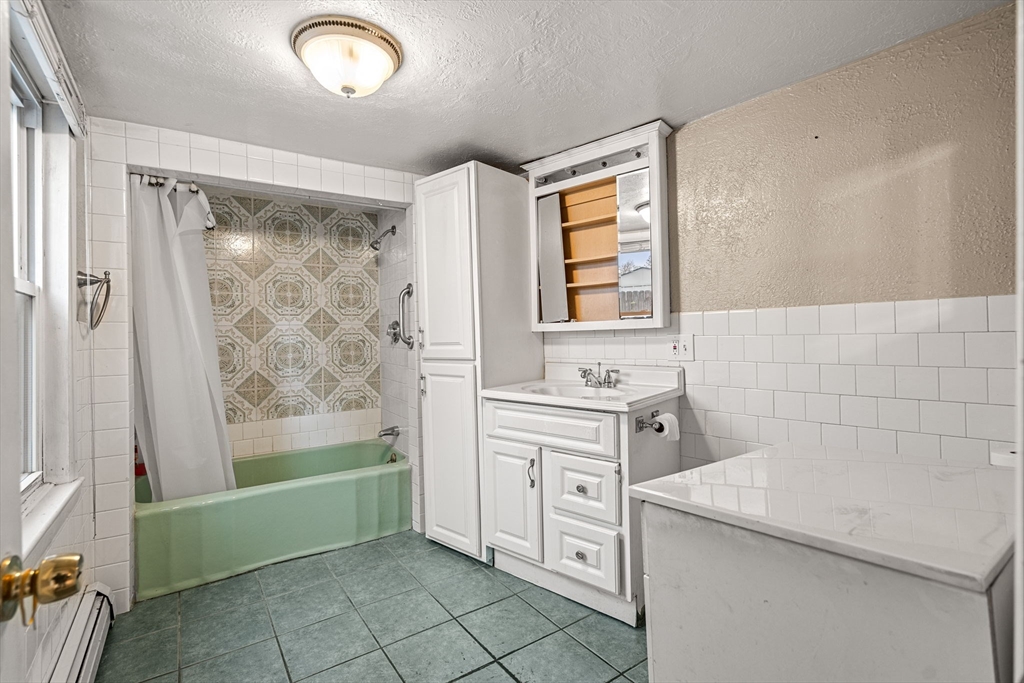 26 Elm Peabody, MA 01960 - Photo 17 of 41 a bathroom with a sink a toilet and shower
