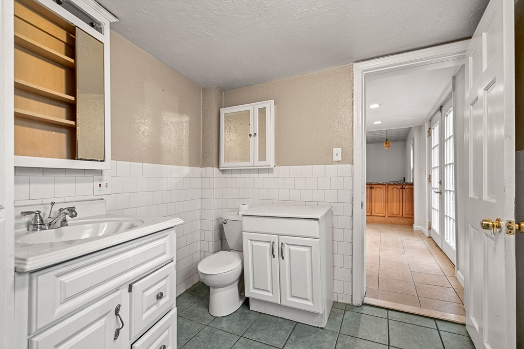 26 Elm Peabody, MA 01960 - Photo 18 of 41 a bathroom with a sink a toilet and a mirror