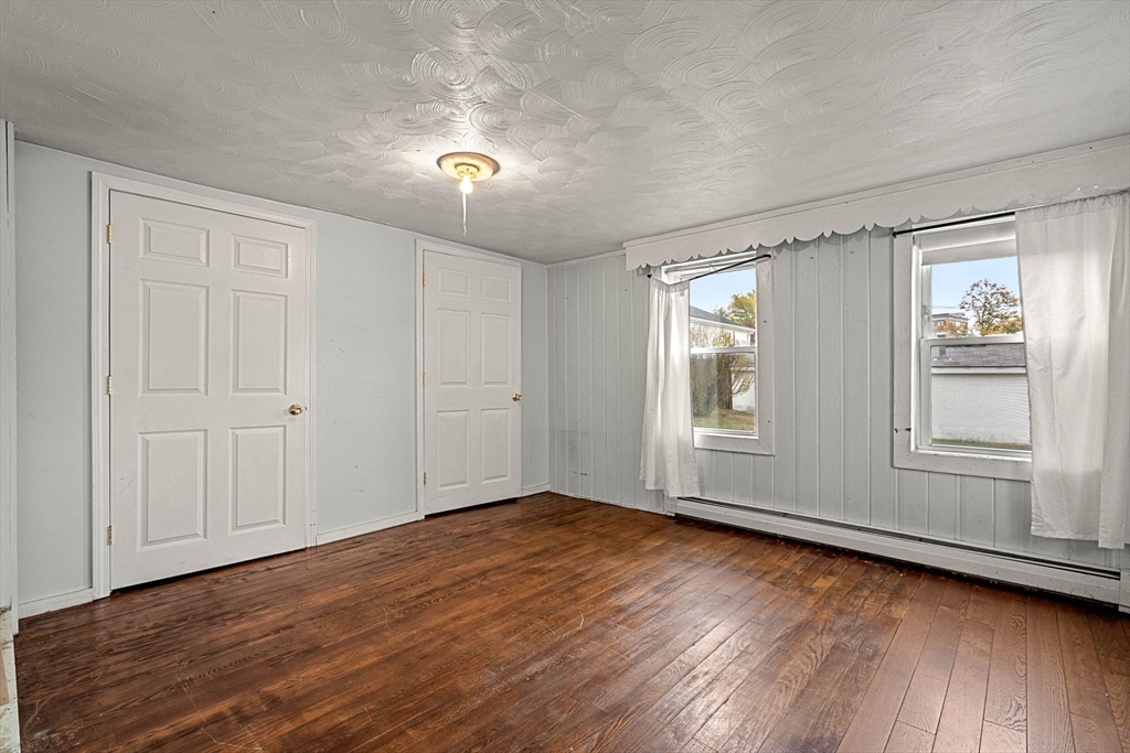 26 Elm Peabody, MA 01960 - Photo 20 of 41 a view of an empty room with wooden floor and a window