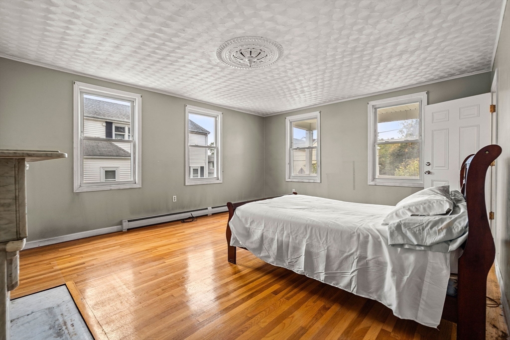 26 Elm Peabody, MA 01960 - Photo 22 of 41 a bedroom with a bed and wooden floor