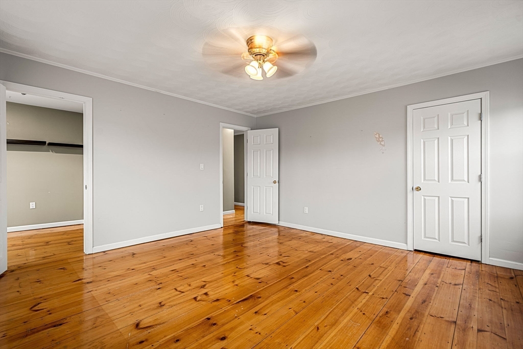 26 Elm Peabody, MA 01960 - Photo 27 of 41 a view of an empty room and chandelier fan and wooden floor