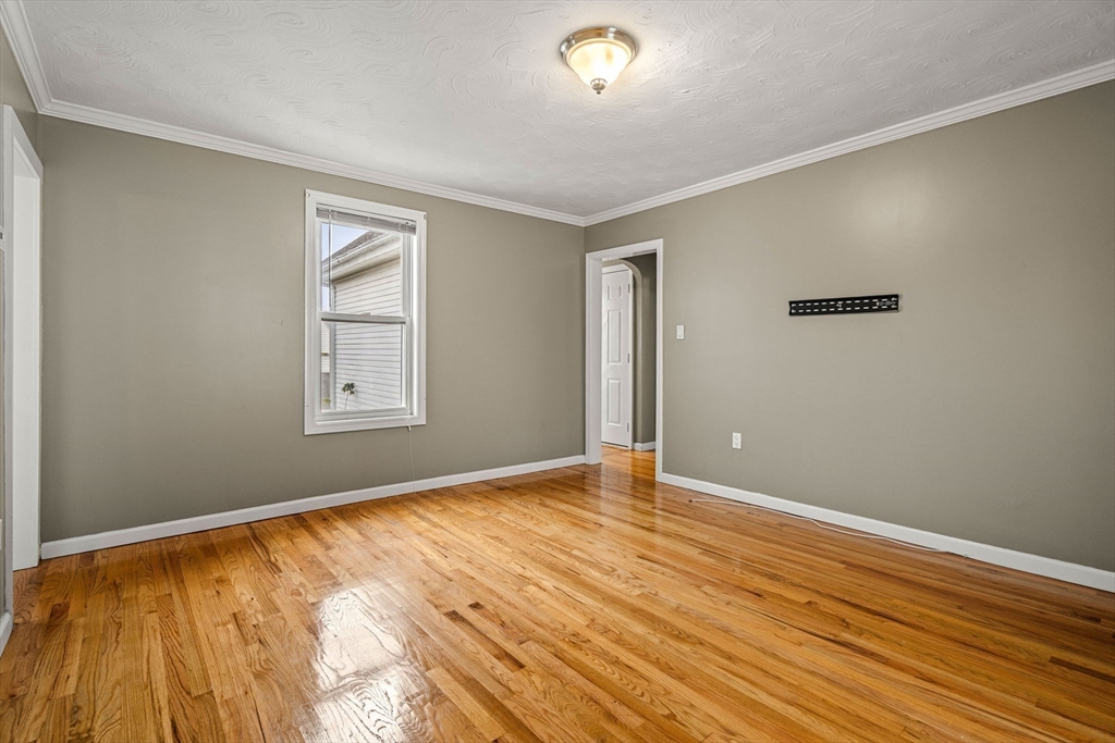 26 Elm Peabody, MA 01960 - Photo 31 of 41 a view of an empty room with wooden floor and a window