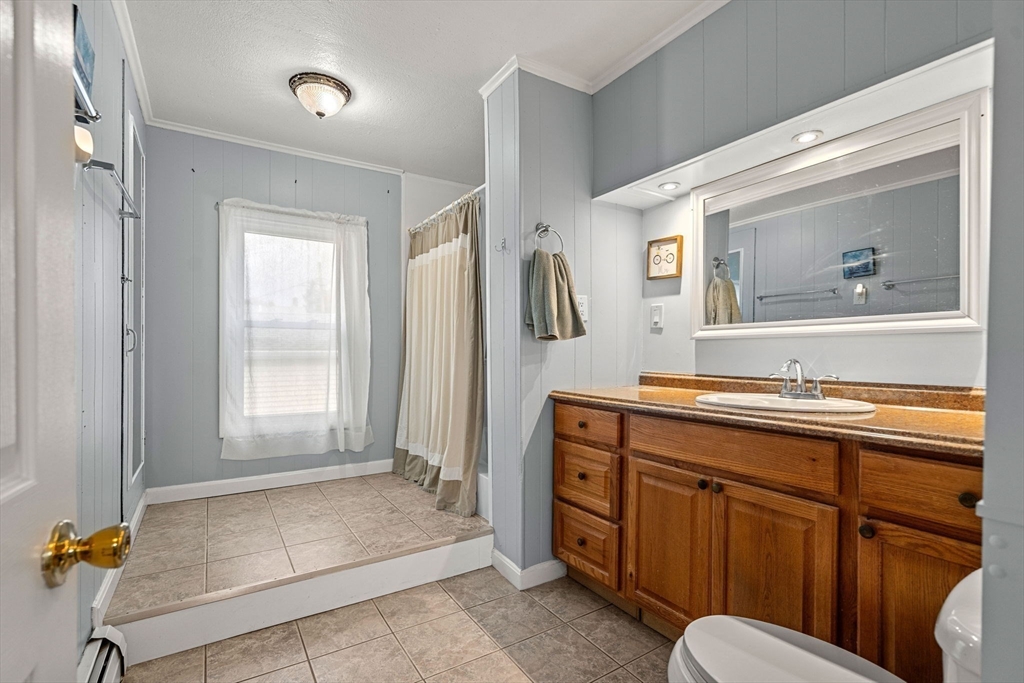 26 Elm Peabody, MA 01960 - Photo 32 of 41 a spacious bathroom with a granite countertop sink and a mirror