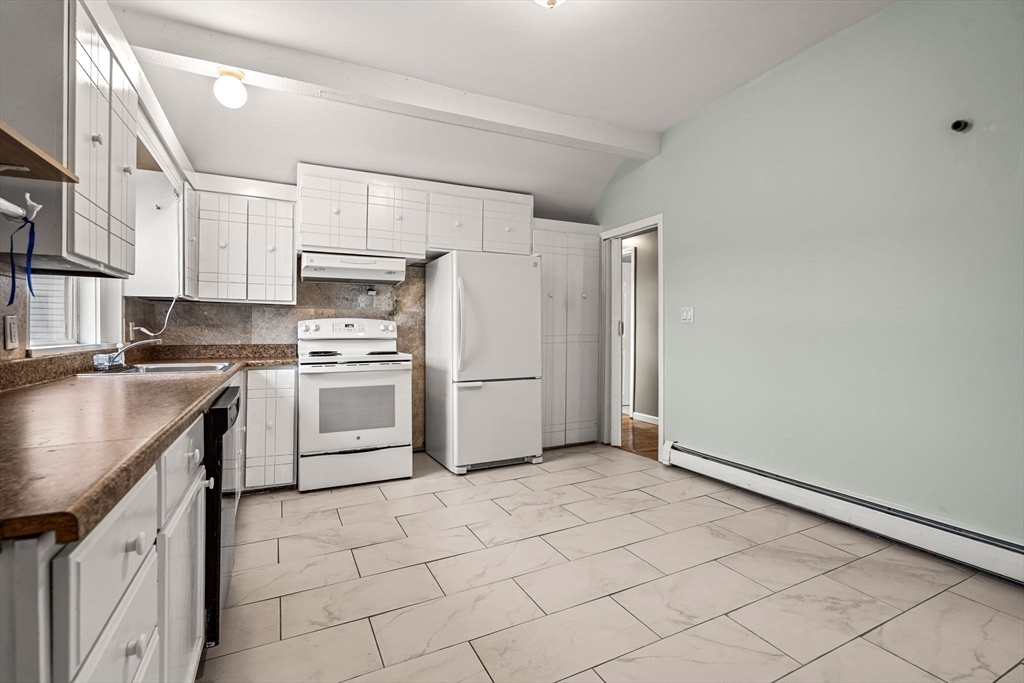 26 Elm Peabody, MA 01960 - Photo 37 of 41 a kitchen with white cabinets and white appliances