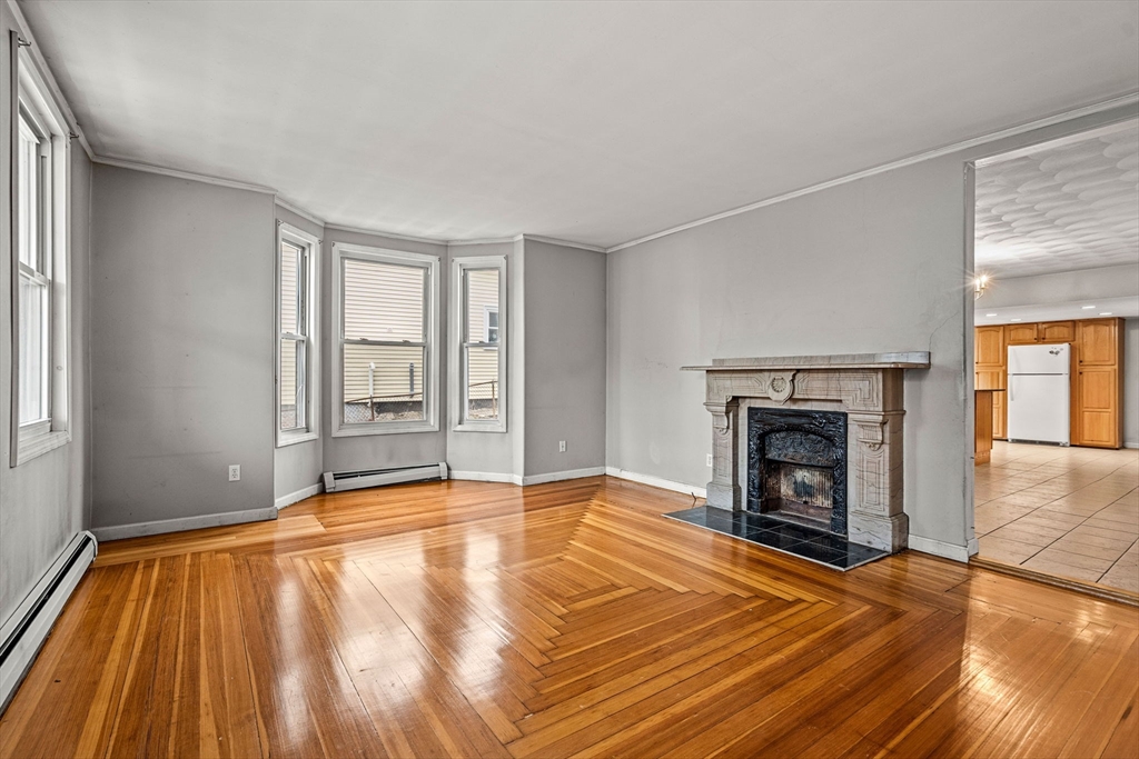 26 Elm Peabody, MA 01960 - Photo 8 of 41 a view of empty room with wooden floor and fireplace