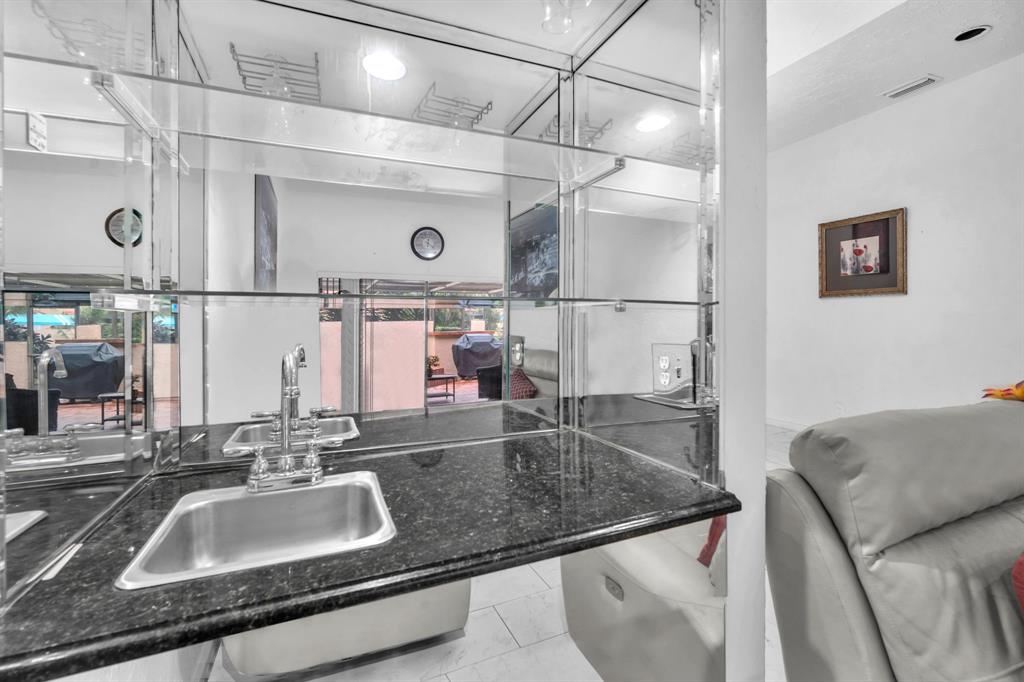 22710 Meridiana Drive Boca Raton, FL 33433 - Photo 13 of 39 a bathroom with a granite countertop sink a mirror and a shower