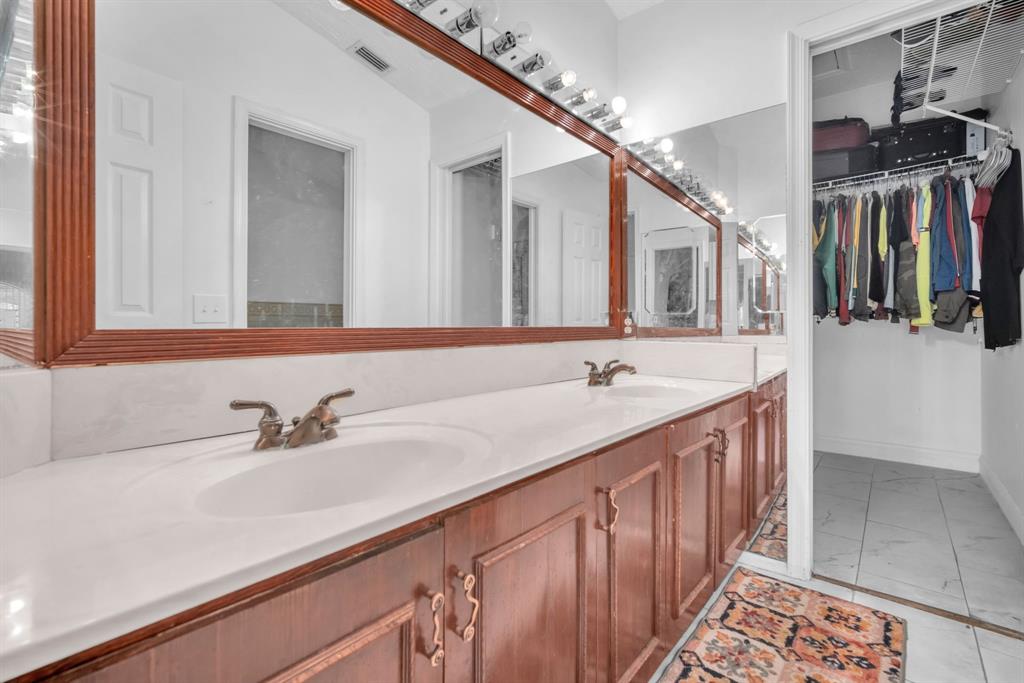 22710 Meridiana Drive Boca Raton, FL 33433 - Photo 17 of 39 a bathroom with a sink and a mirror