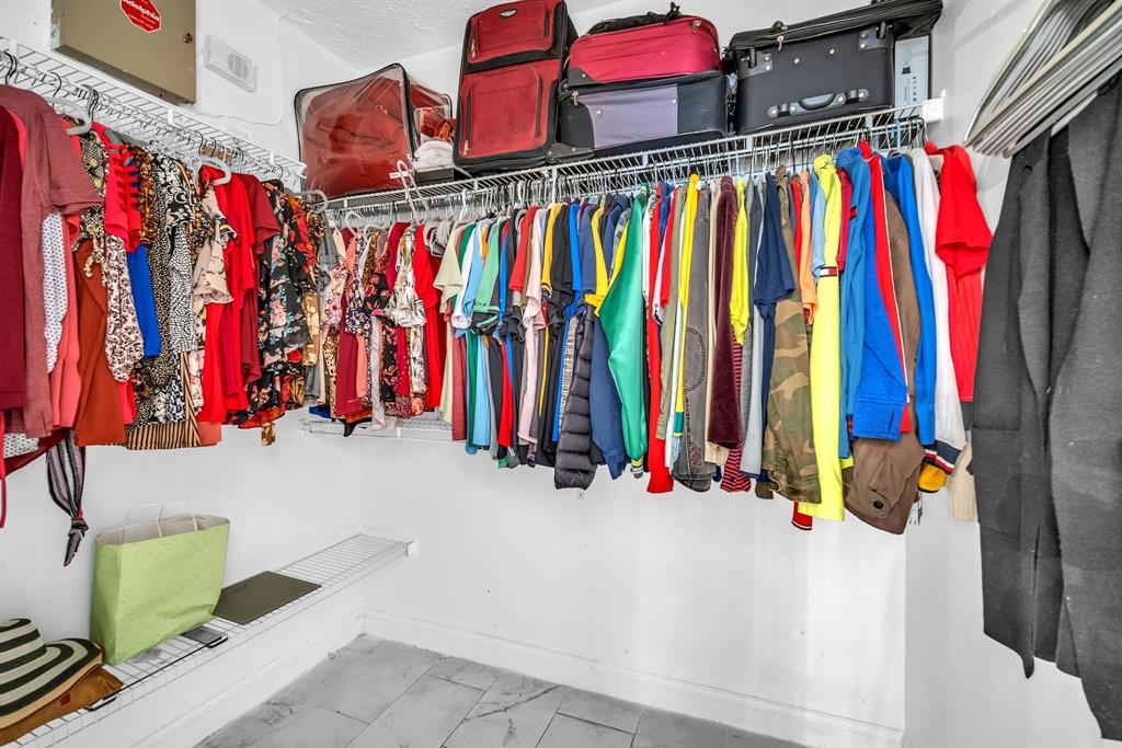 22710 Meridiana Drive Boca Raton, FL 33433 - Photo 21 of 39 a view of walk in closet with clothes