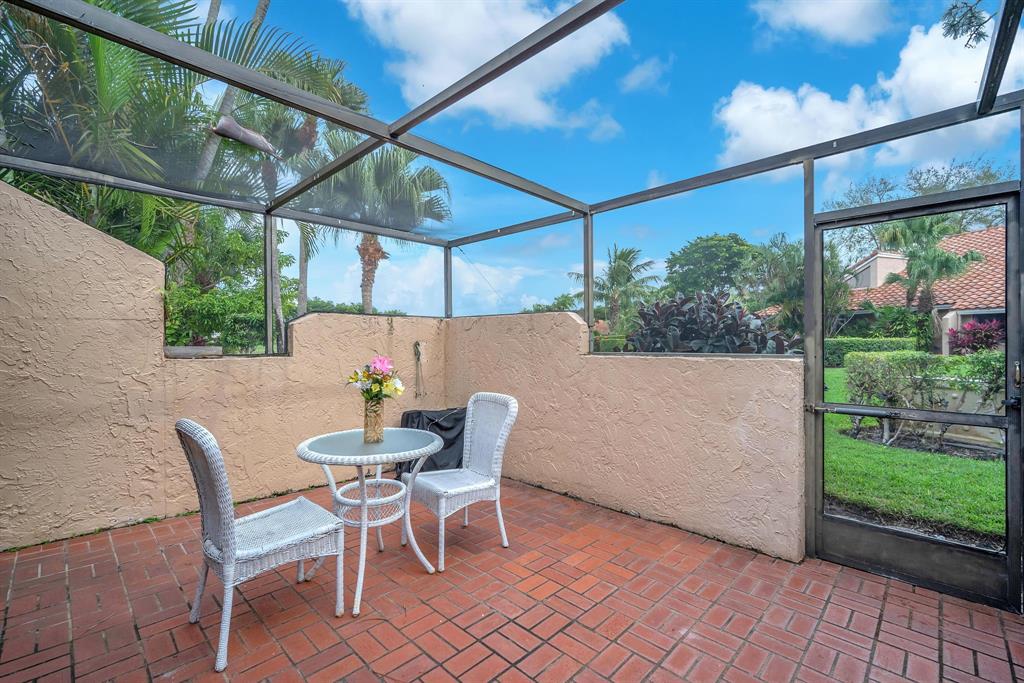22710 Meridiana Drive Boca Raton, FL 33433 - Photo 24 of 39 a patio with a yard table and chairs