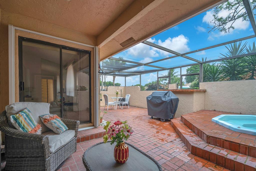 22710 Meridiana Drive Boca Raton, FL 33433 - Photo 26 of 39 a living room with patio furniture and a potted plant