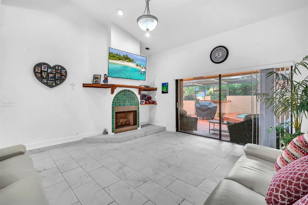 22710 Meridiana Drive Boca Raton, FL 33433 - Photo 5 of 39 a living room with furniture and a flat screen tv