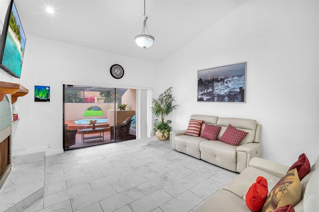 22710 Meridiana Drive Boca Raton, FL 33433 - Photo 6 of 39 a living room with furniture and a flat screen tv