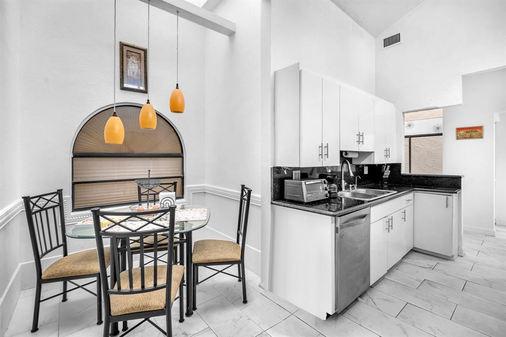 22710 Meridiana Drive Boca Raton, FL 33433 - Photo 8 of 39 a kitchen that has a table and chairs in it