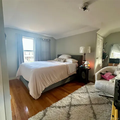a bedroom with a bed and window