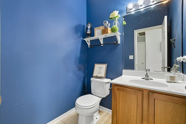 a bathroom with a sink vanity mirror and toilet