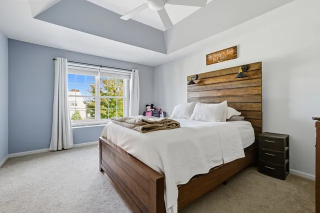 a bed sitting in a bedroom next to a window