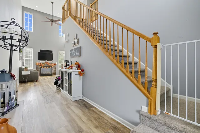 a view of stairs and an entryway with wooden floor