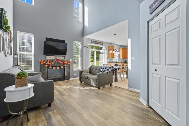 a living room with furniture a flat screen tv and wooden floor
