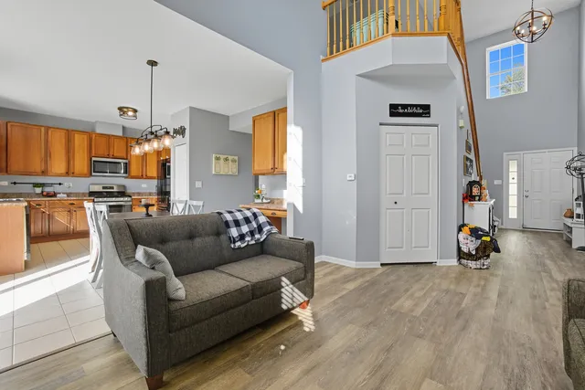 a living room with furniture and a chandelier