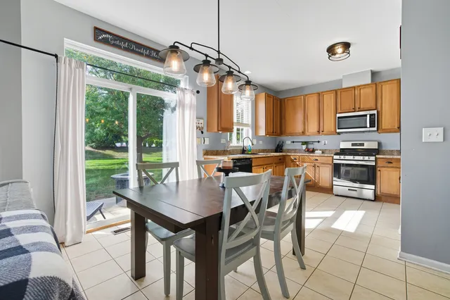 a kitchen with a table chairs and microwave