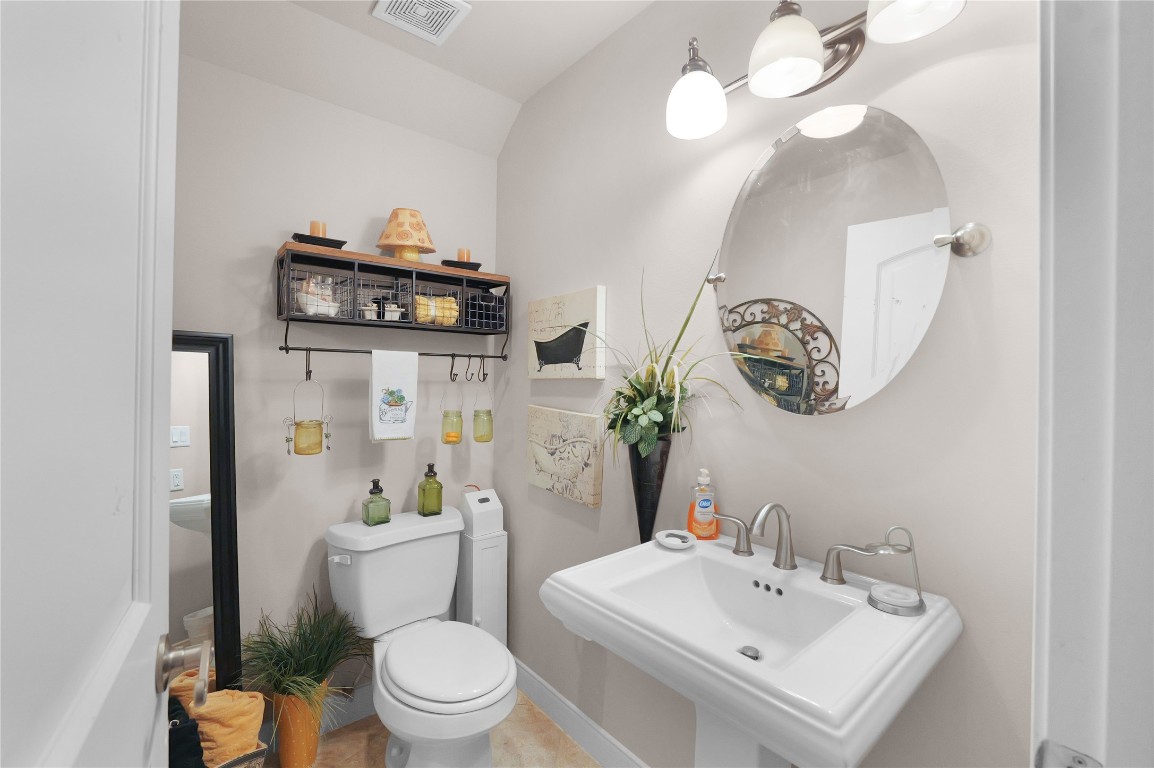 11 Lookout Ridge Huntsville, TX 77340 - Photo 33 of 45 a bathroom with a sink a toilet and a mirror