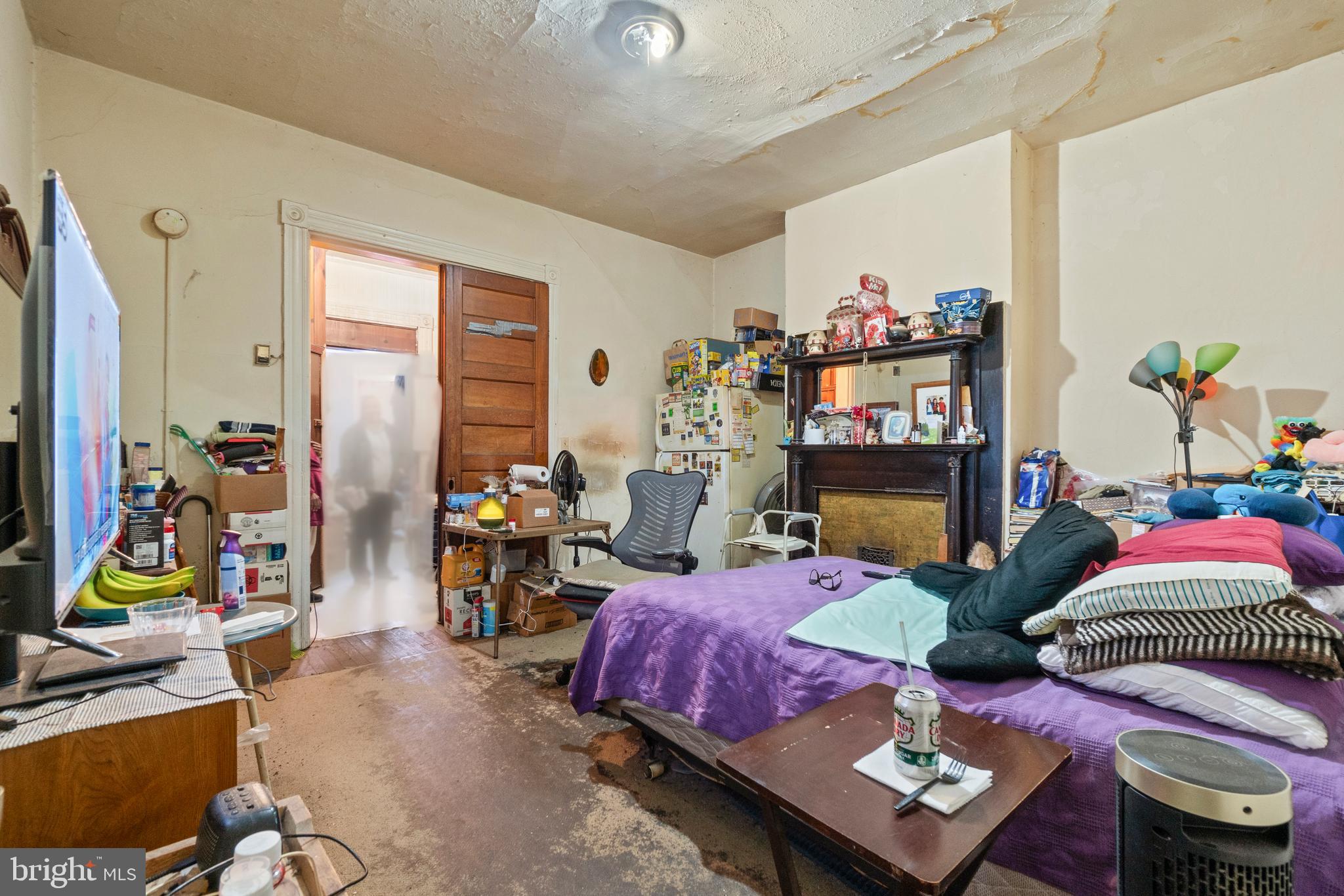 112 East 20th Street Baltimore, MD 21218 - Photo 11 of 23 a bedroom with bed and a mirror