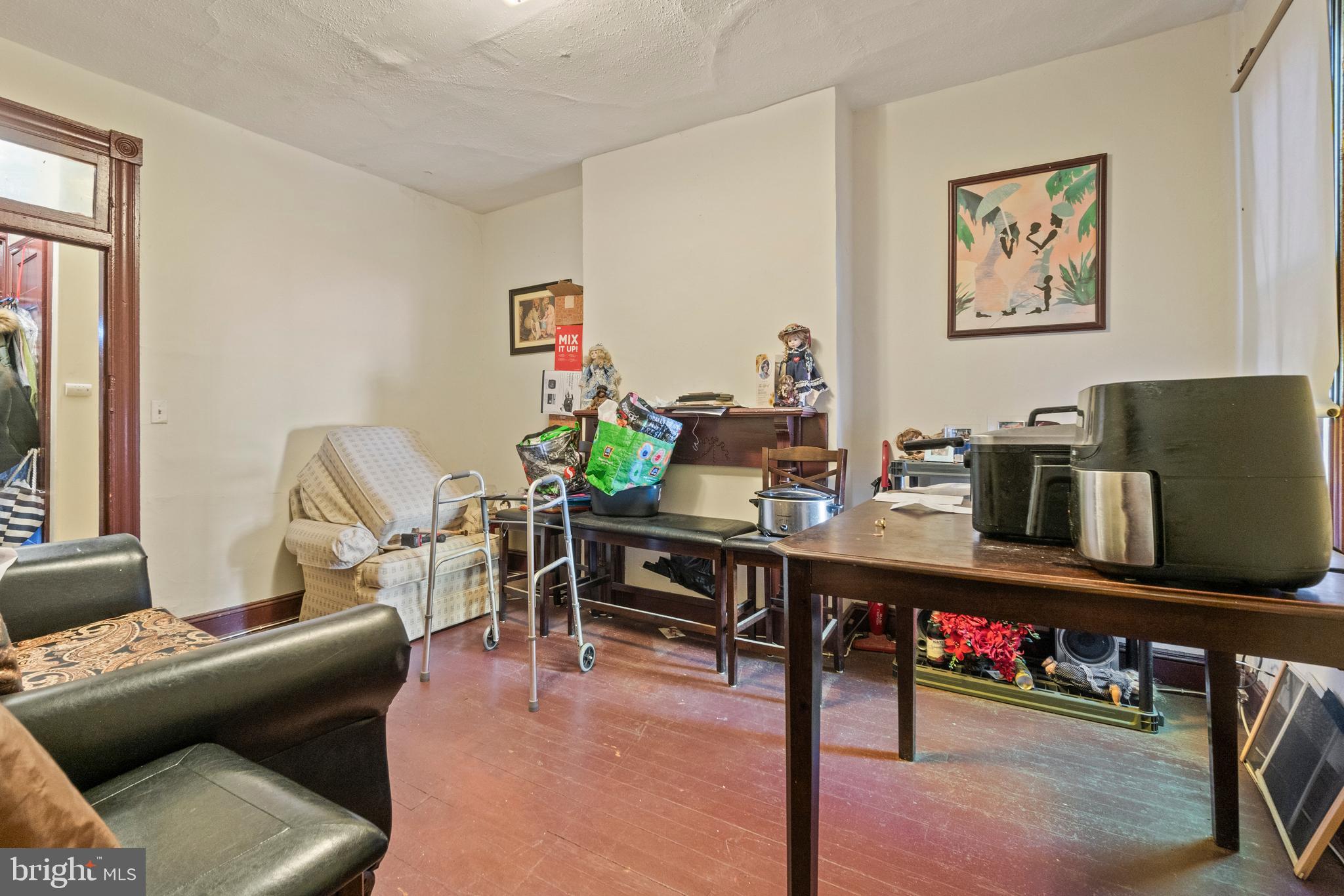 112 East 20th Street Baltimore, MD 21218 - Photo 13 of 23 a living room with furniture and wooden floor