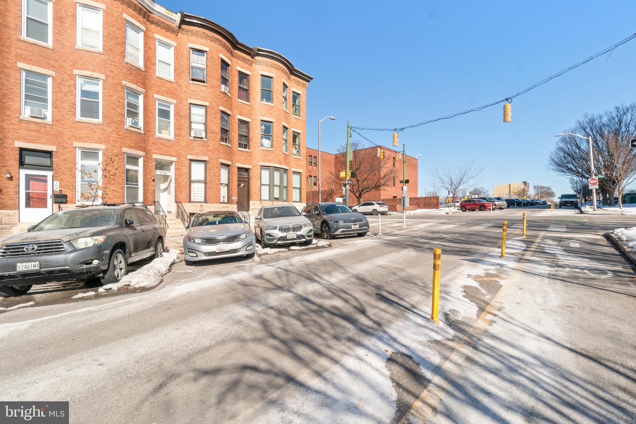 112 East 20th Street Baltimore, MD 21218 - Photo 23 of 23 a city street lined with parked cars and buildings