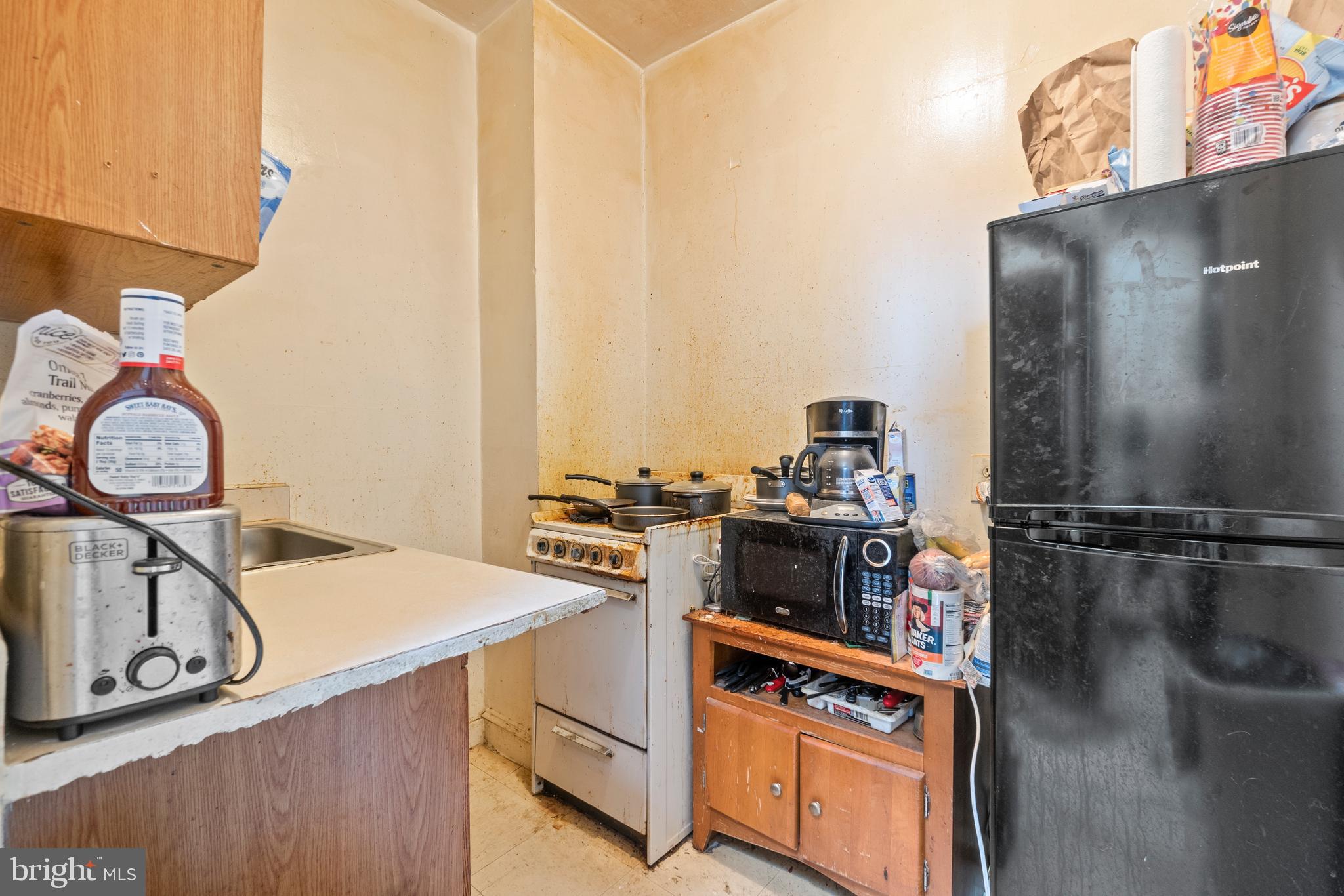 112 East 20th Street Baltimore, MD 21218 - Photo 3 of 23 a view of a kitchen with a stove top oven and sink