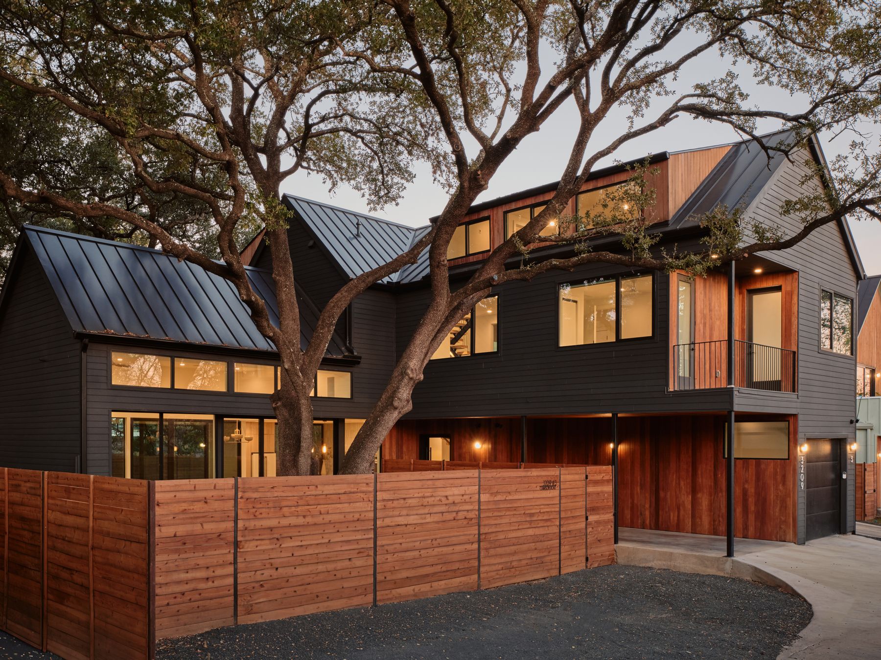 a view of a house with a large tree