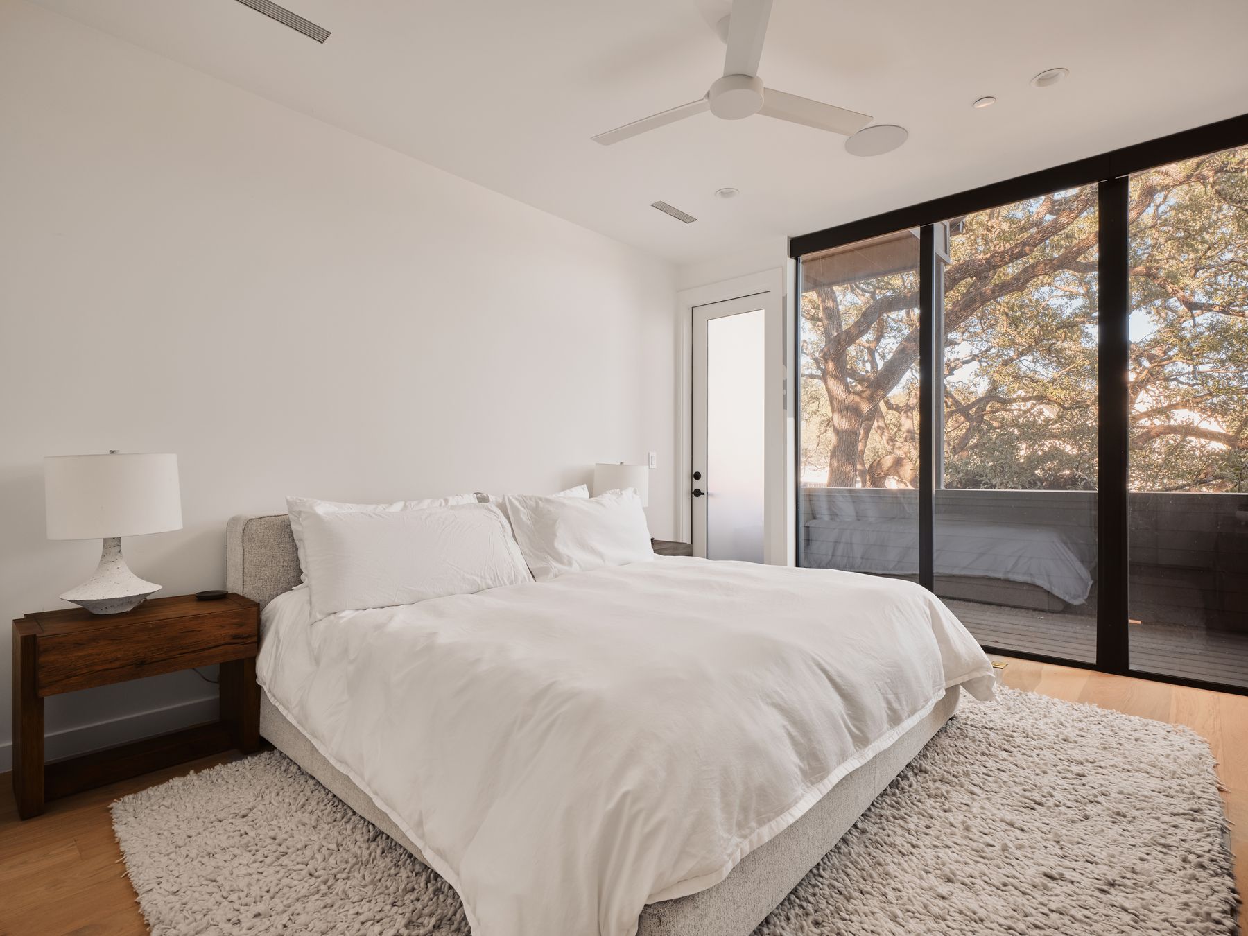3209 Clawson Road Austin, TX 78704 - Photo 17 of 30 a bedroom with a large bed and a large window
