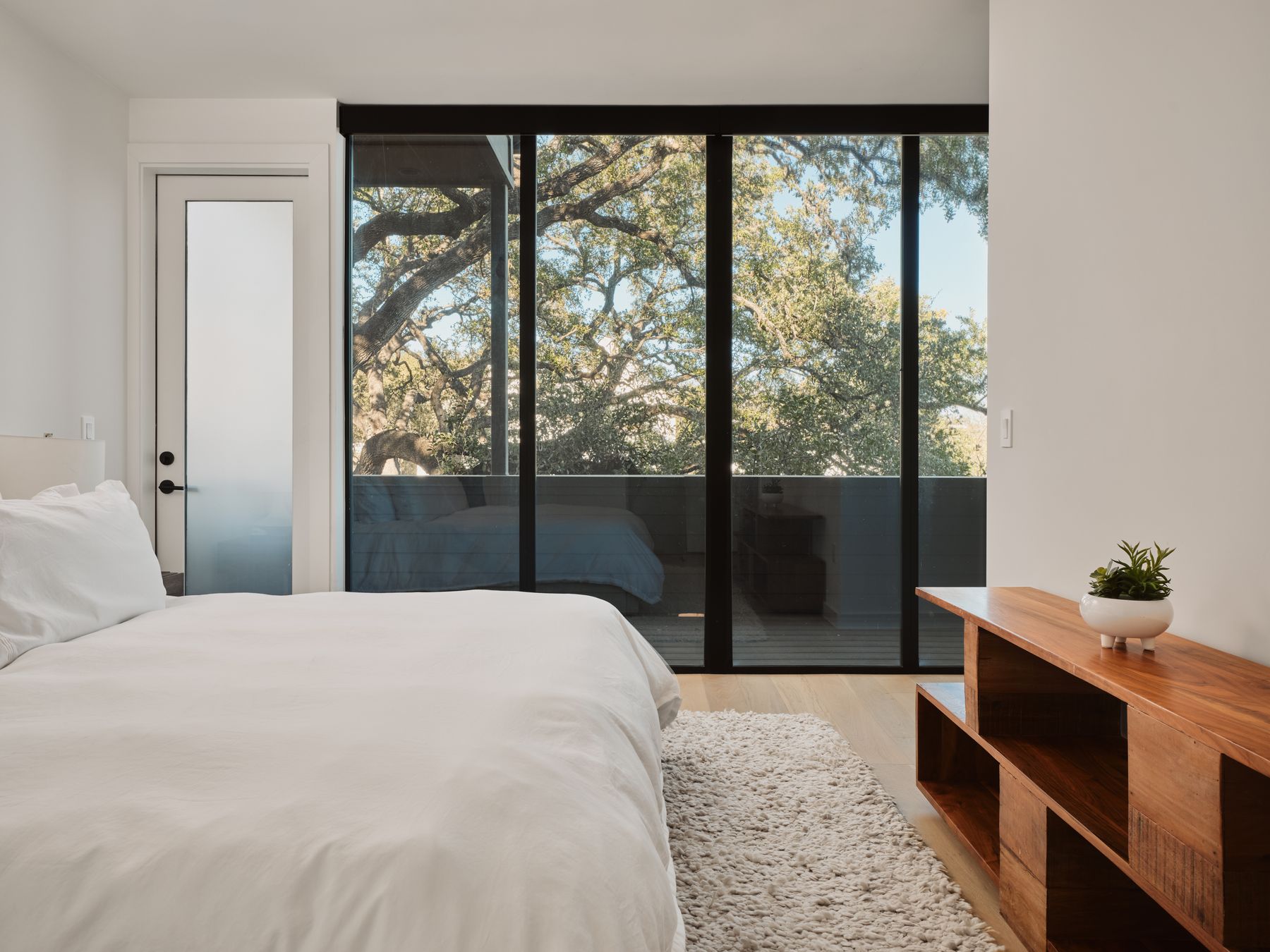 3209 Clawson Road Austin, TX 78704 - Photo 18 of 30 a bedroom with a bed and large window