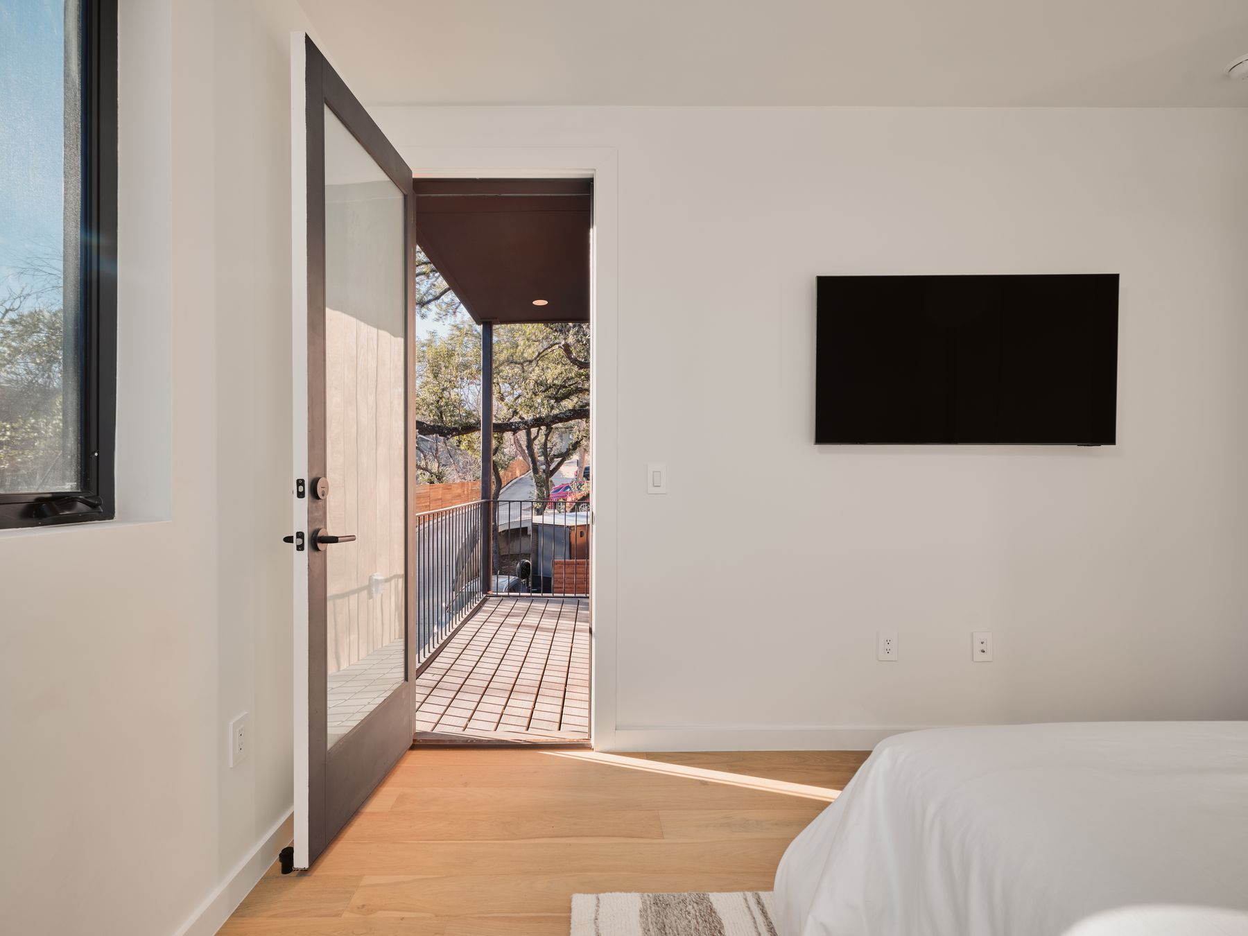 3209 Clawson Road Austin, TX 78704 - Photo 19 of 30 a bedroom with a bed and a flat screen tv