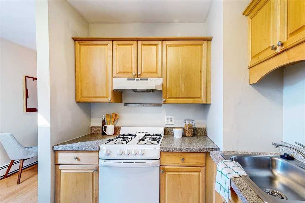 29 Eden Street, Unit 3 Boston, MA 02129 - Photo 11 of 15 a kitchen with stainless steel appliances granite countertop a sink stove and cabinets