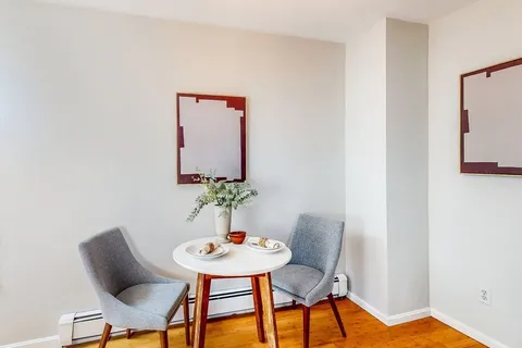 a view of a room that has a table and chair in it