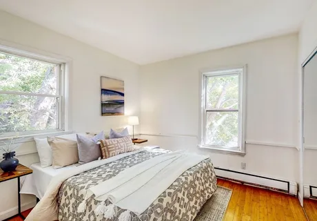 a bedroom with bed and a window