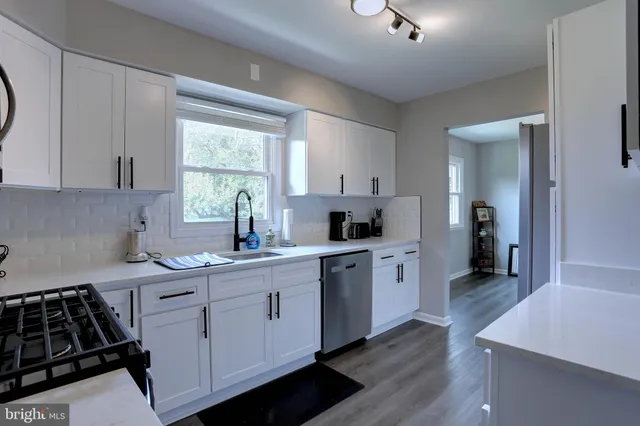 a kitchen with a sink stove and cabinets