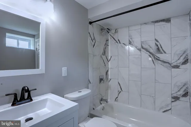 a bathroom with a toilet and a bathtub