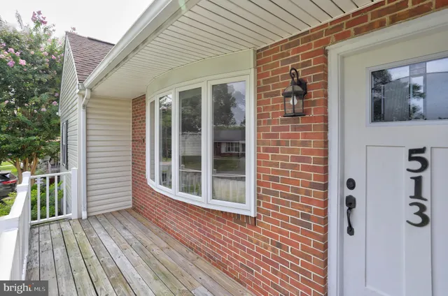 a view of a house with deck and wooden floor