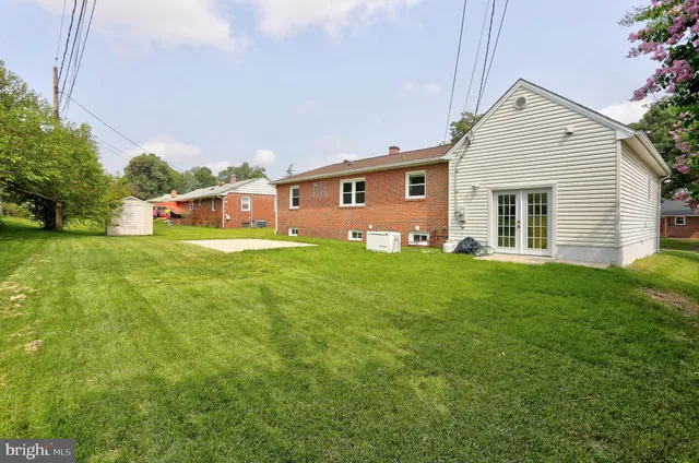 a view of a house with a yard and sitting area