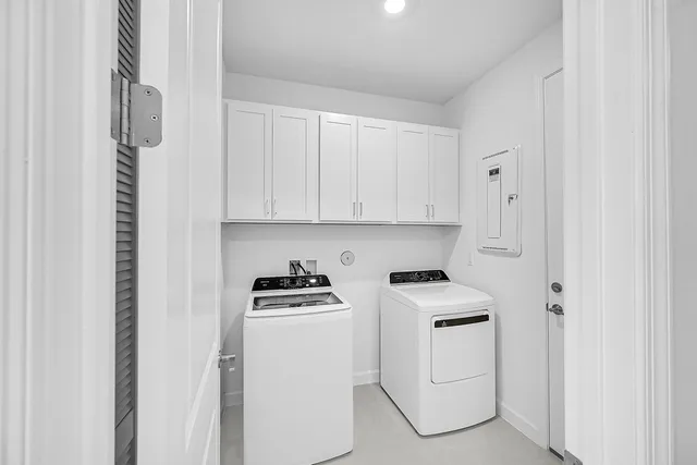 a room with white cabinets and white appliances