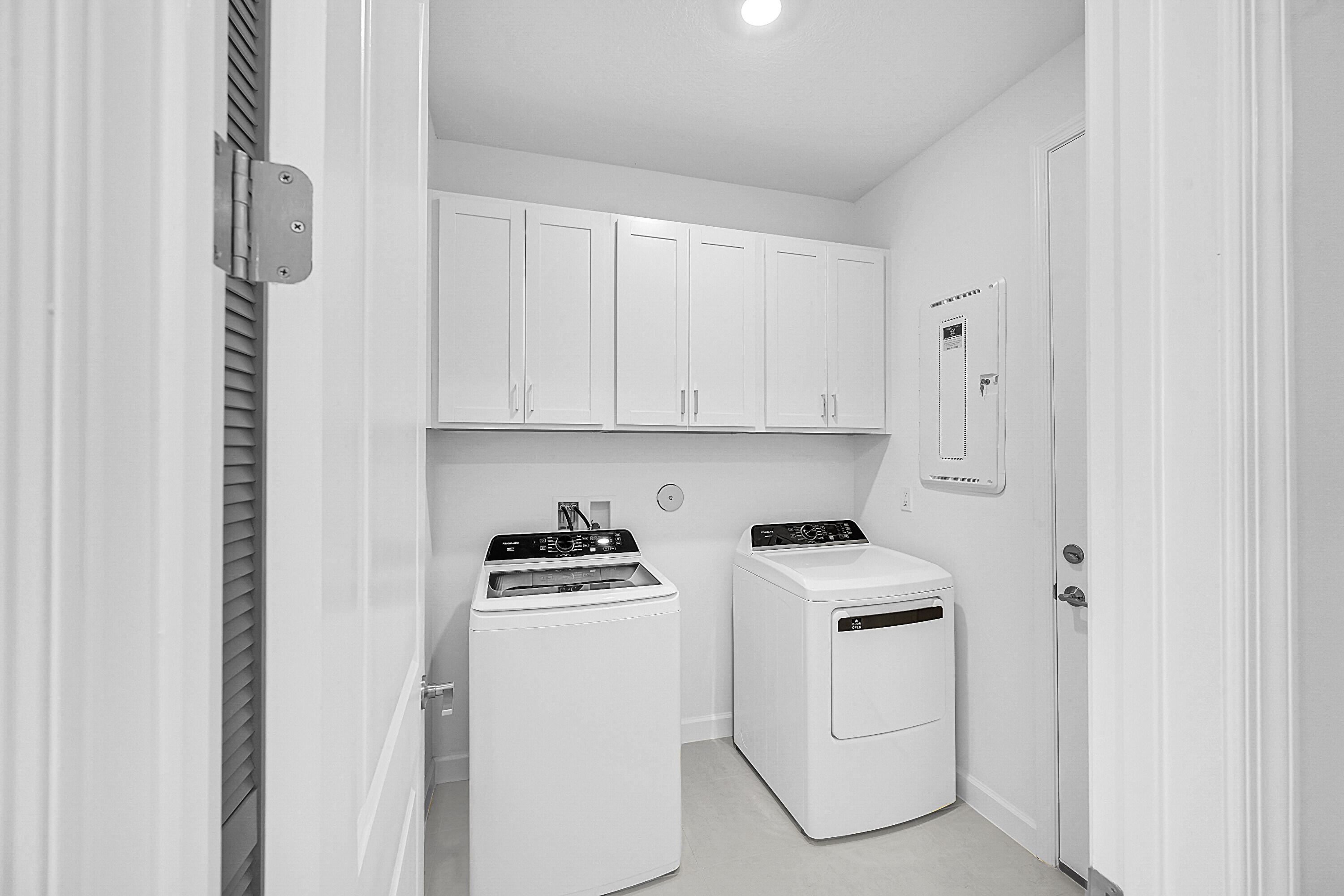 3532 Angler Drive Fort Pierce, FL 34946 - Photo 12 of 31 a room with white cabinets and white appliances
