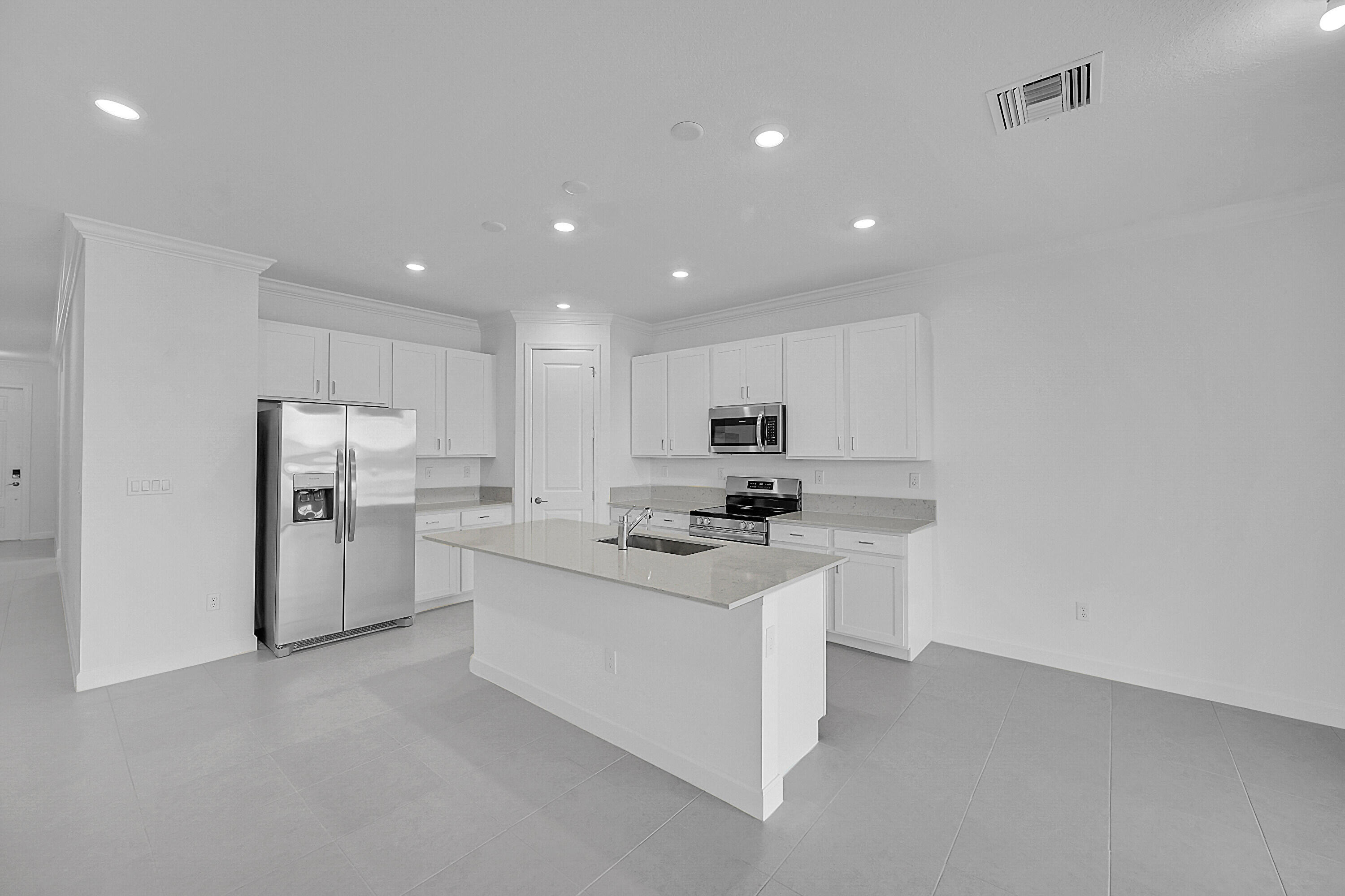 3532 Angler Drive Fort Pierce, FL 34946 - Photo 18 of 31 a kitchen with stainless steel appliances a sink stove and refrigerator