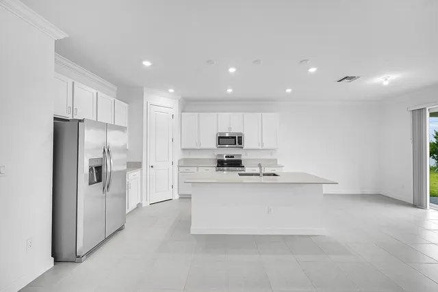 a kitchen with stainless steel appliances a sink stove and refrigerator